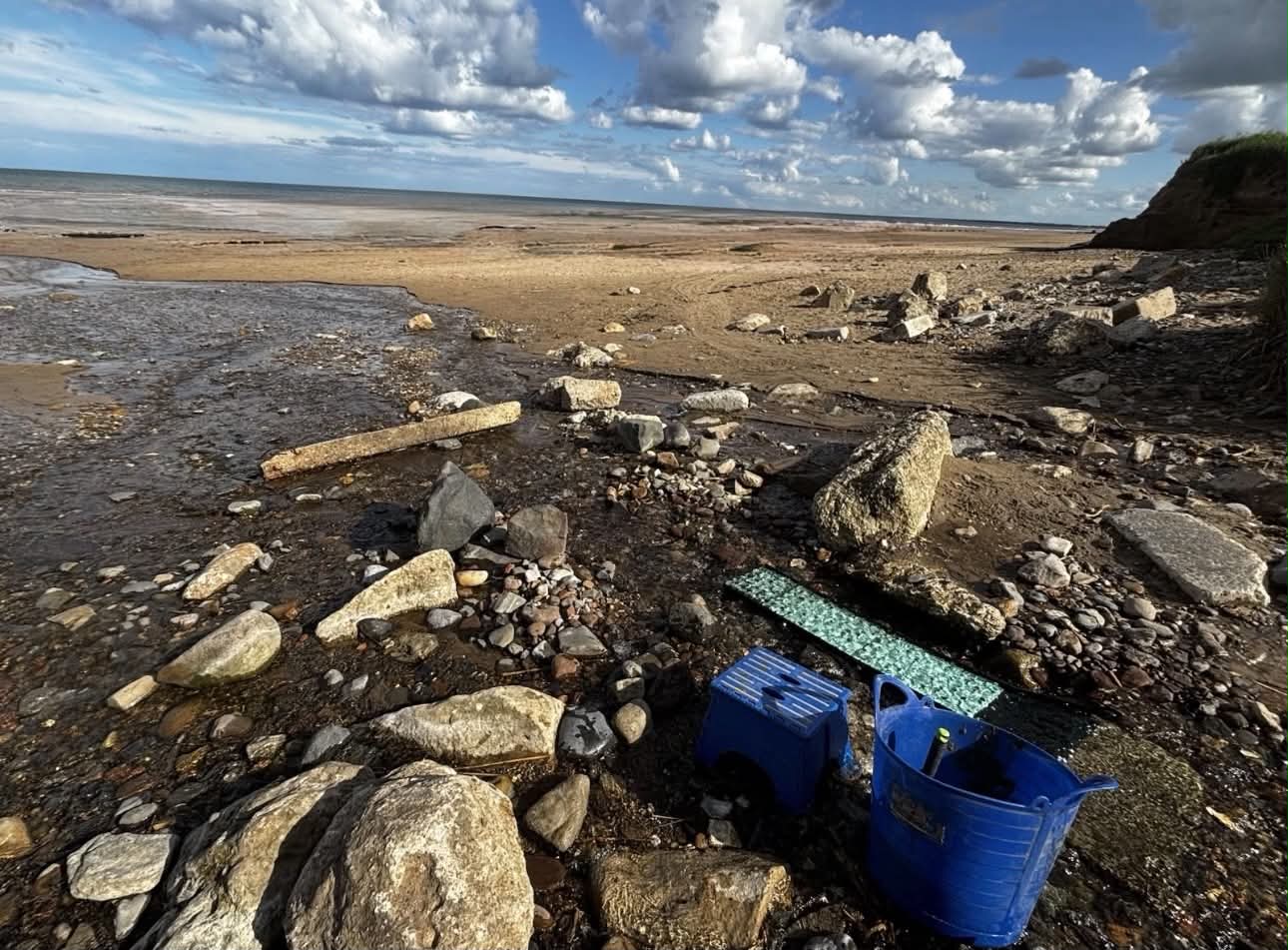 Gold recovery gear — trug, classifier and fine-gold matting — set up on a UK foreshore