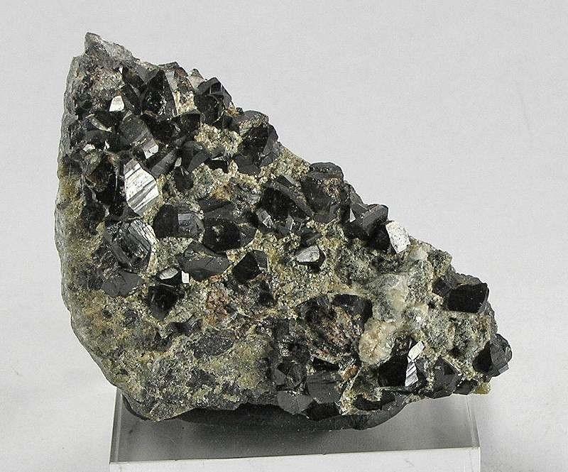 Dark brown to black cassiterite (tin oxide) crystals with a bright adamantine lustre.