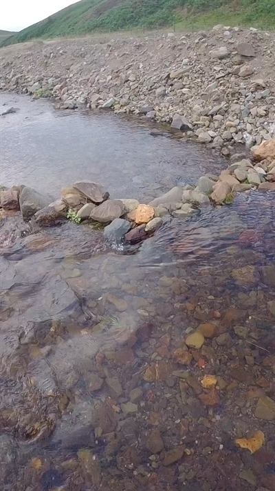 A Scottish burn running over gravel